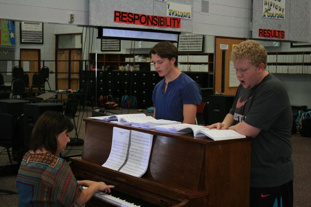 Junior Dalton Kizer (left) and senior Zane Gray (right) rehearse for musical theatre with chorus teacher Ms. Mary Sexton.