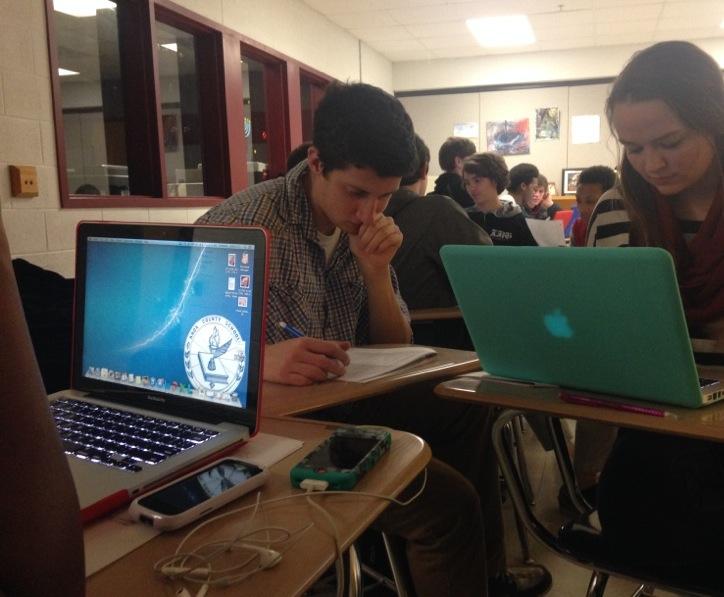 Mary Lyle works on her laptop in English class this week, while Andrew Flores looks on.