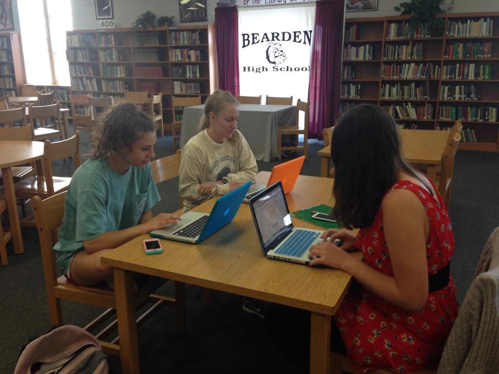 Seniors Olivia Johnson, MacKenzie Goff, and Michelle Lames (left to right) work on their STEM project after school in the library.