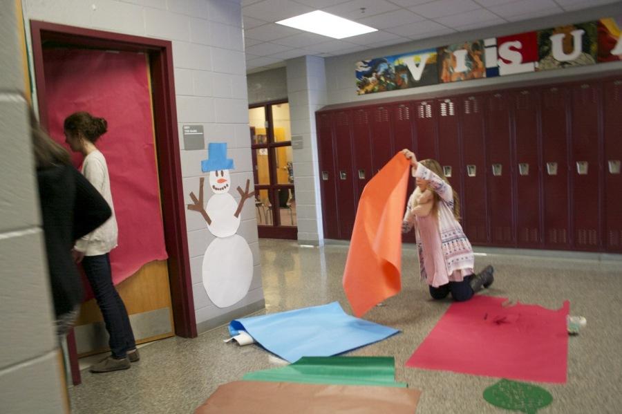 Students work with brightly colored paper to make the doors in Beardens hallways as festive as possible.