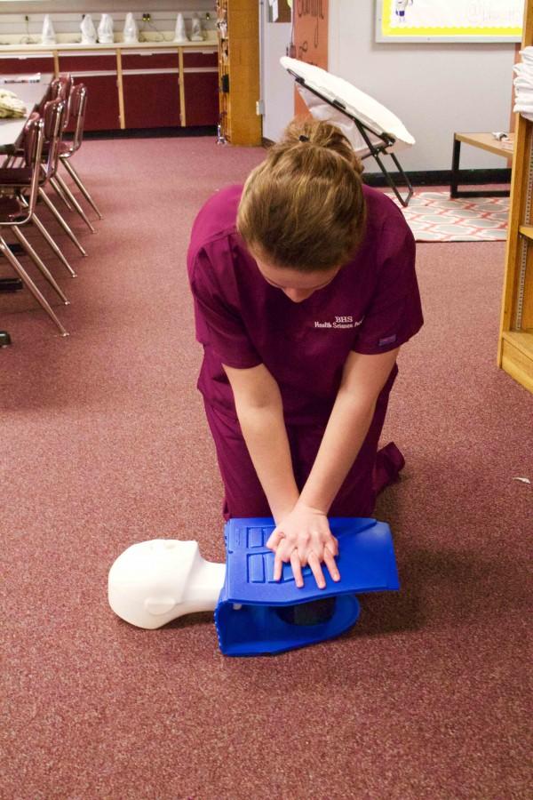 Bearden senior Avery McKinney practices on a CPR dummy.