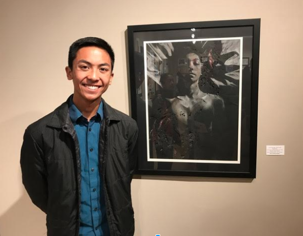 Bearden senior Justin Edaugal stands in front of one of his pieces that took home a gold key at the Scholastic Art and Writing Awards competition.