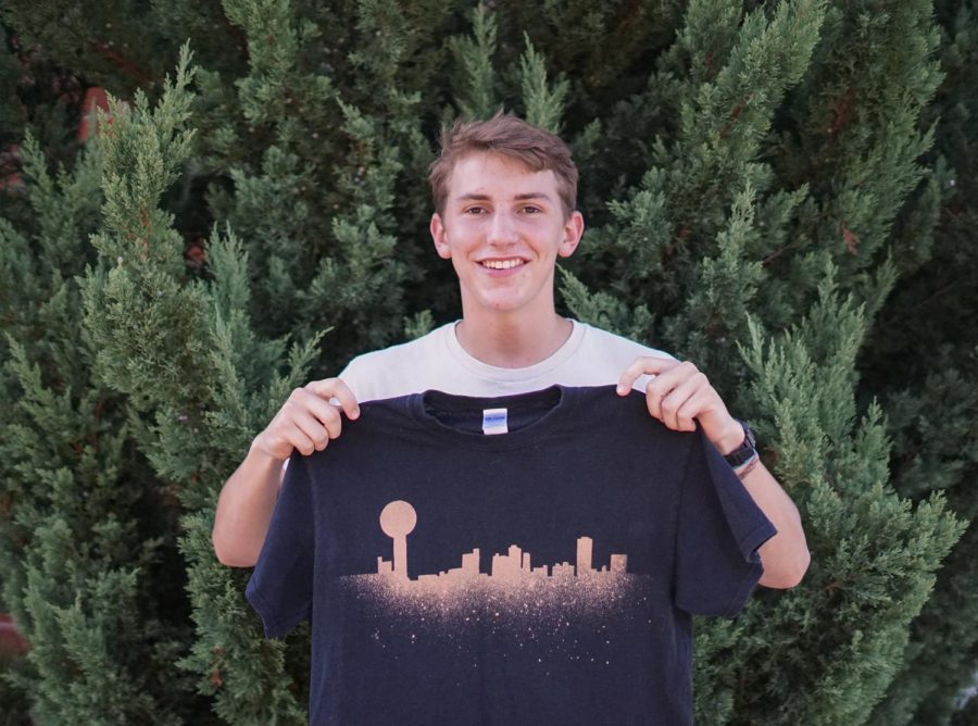 Colby Moldrup poses with his most popular design – the Knoxville skyline with the Sunsphere.