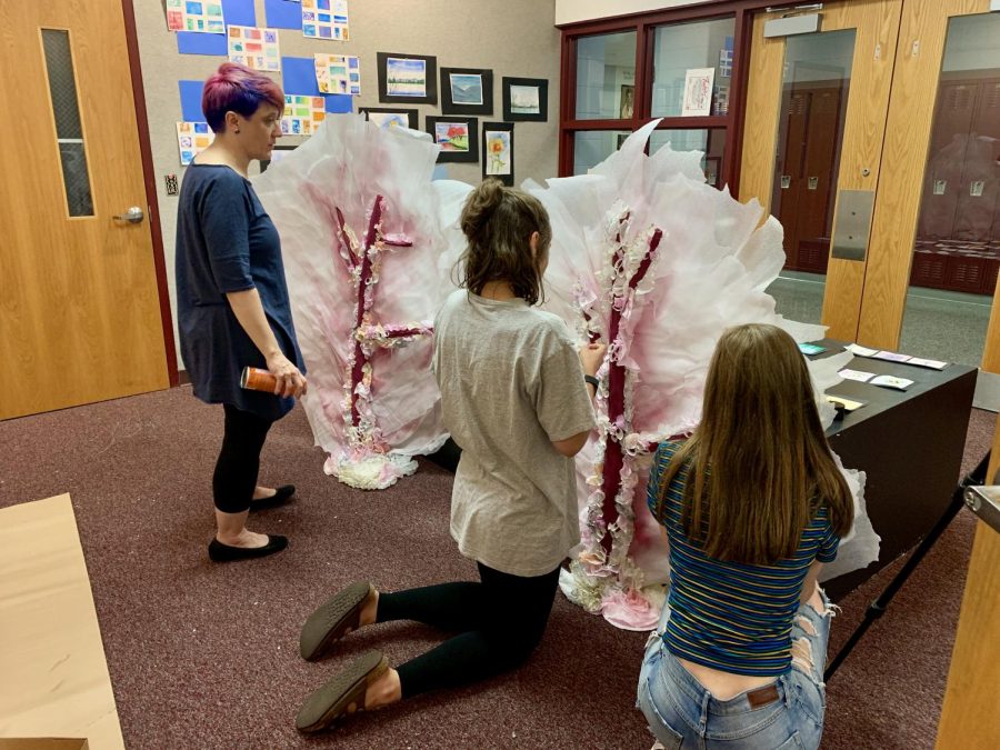 Mrs. Victoria May looks on as prom committee members work on designing decorations in the art gallery this week.