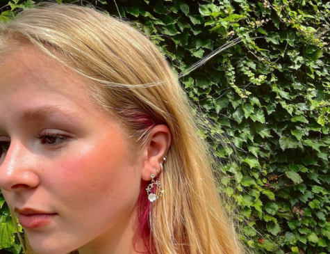 Sophomore Abby Lauren models earrings that she sells on her store NostalgicWear.