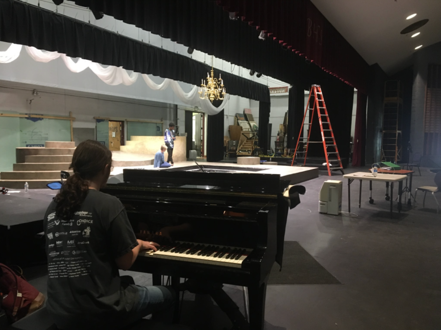Bearden senior Eli Atkin watches, as director Ms. Katie Alley works with her students. Atkin has taken much of his inspiration for his original score for Metamorphoses by carefully observing the actors performances.
