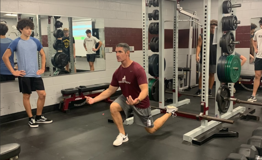 Coach Morgan Shinlever works with his weightlifting students in class. Coach Shinlever is excited about his second stint as athletics director.