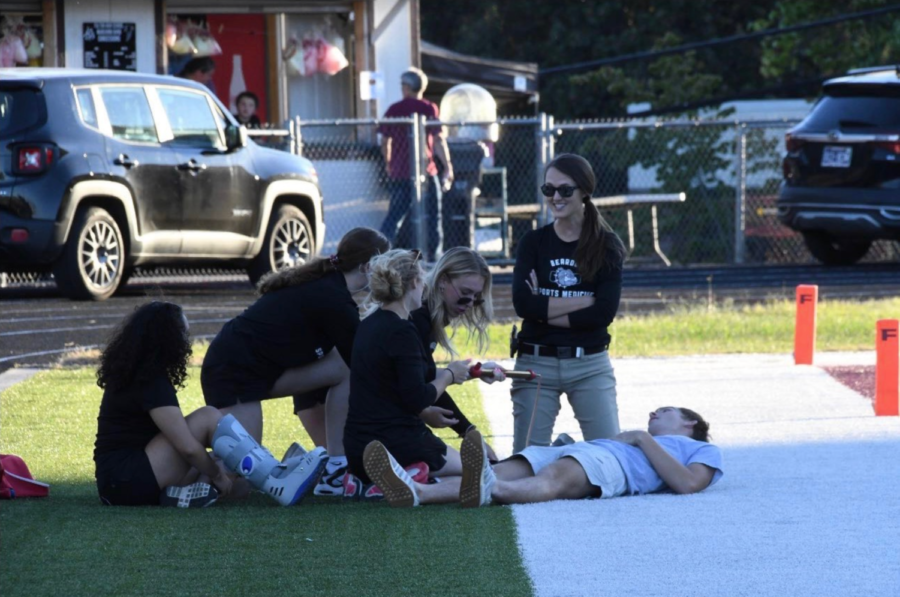 Bearden athletic trainer Nicole Medina practices treatment with her student assistants.