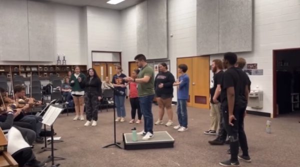 Mr. Steven Brown rehearses with cast members and Bearden orchestra students for upcoming performances of The Music Man.