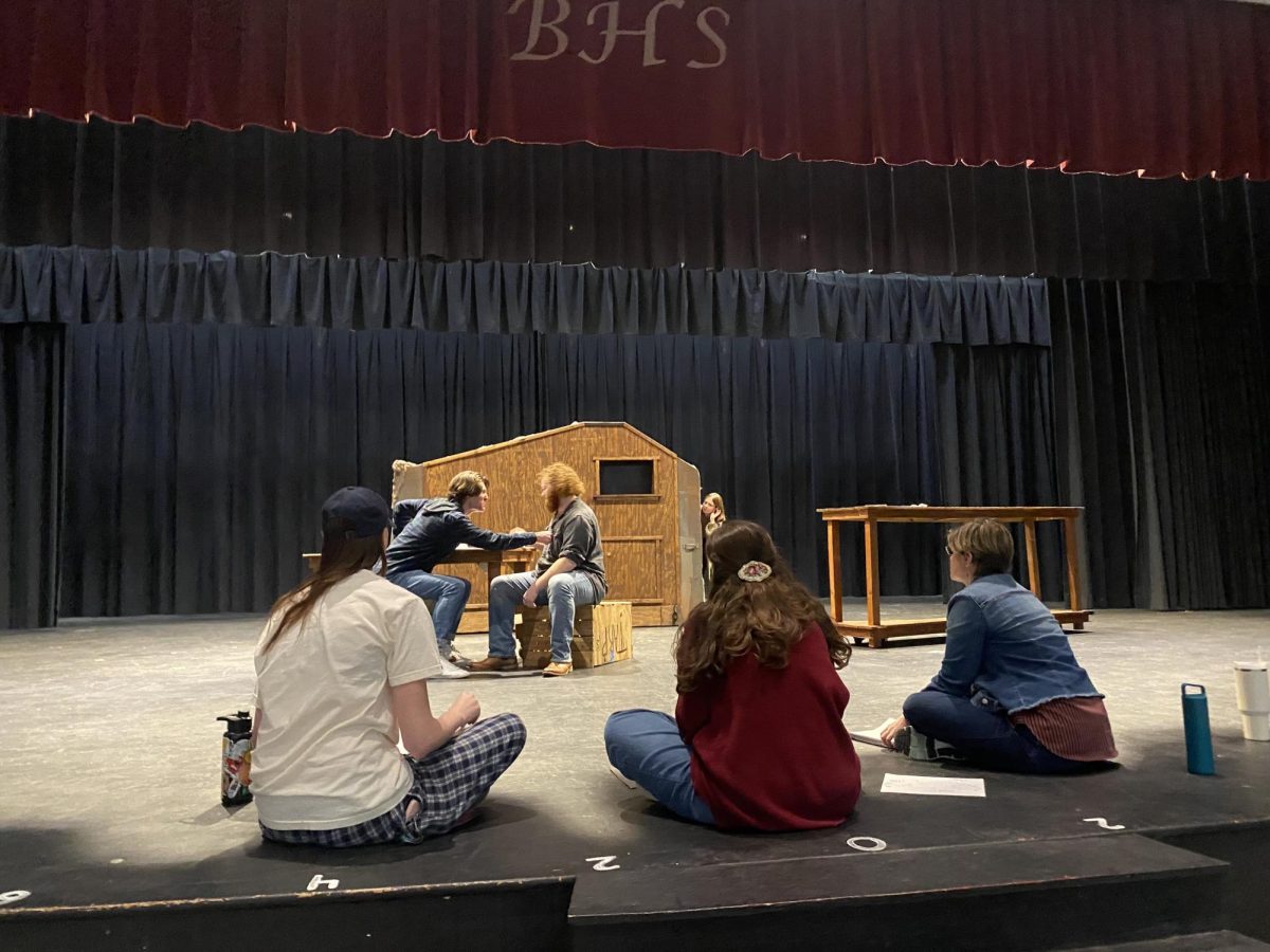 Taylor Haun (left) and Jack Stapleton (right) rehearse for Treasure Island, as director Ms. Katie Alley and other students look on.