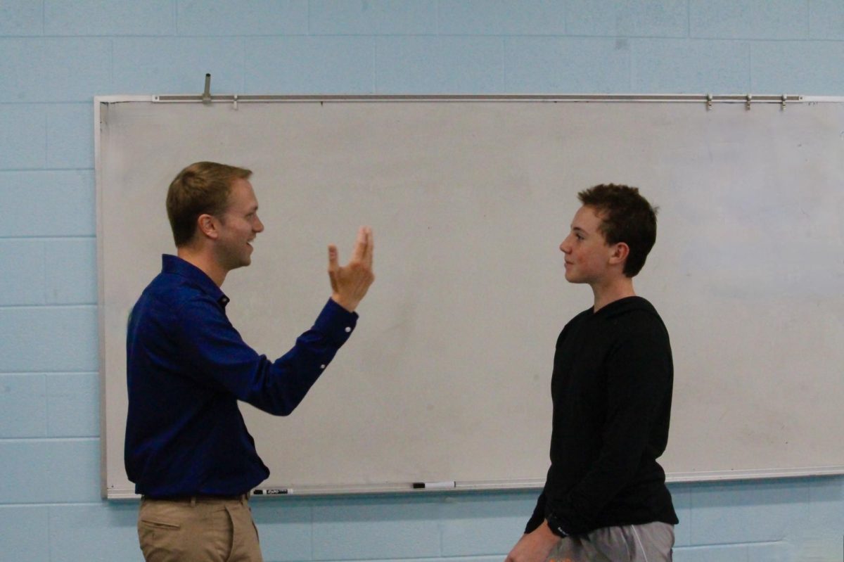 BLC teacher Mr. Logan Peterson talks to junior Bobby Powell during 45 this week.