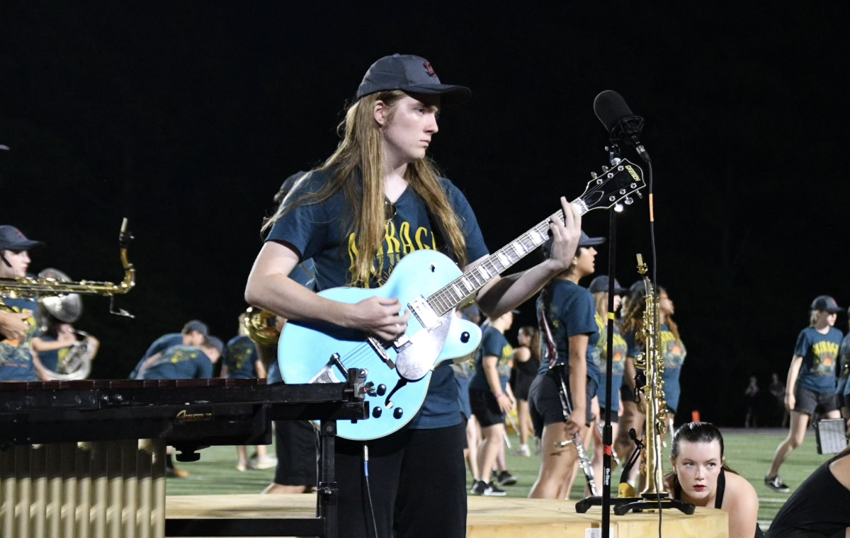 Senior Bradley Witzel plays his guitar solo during halftime at a Bearden football game.