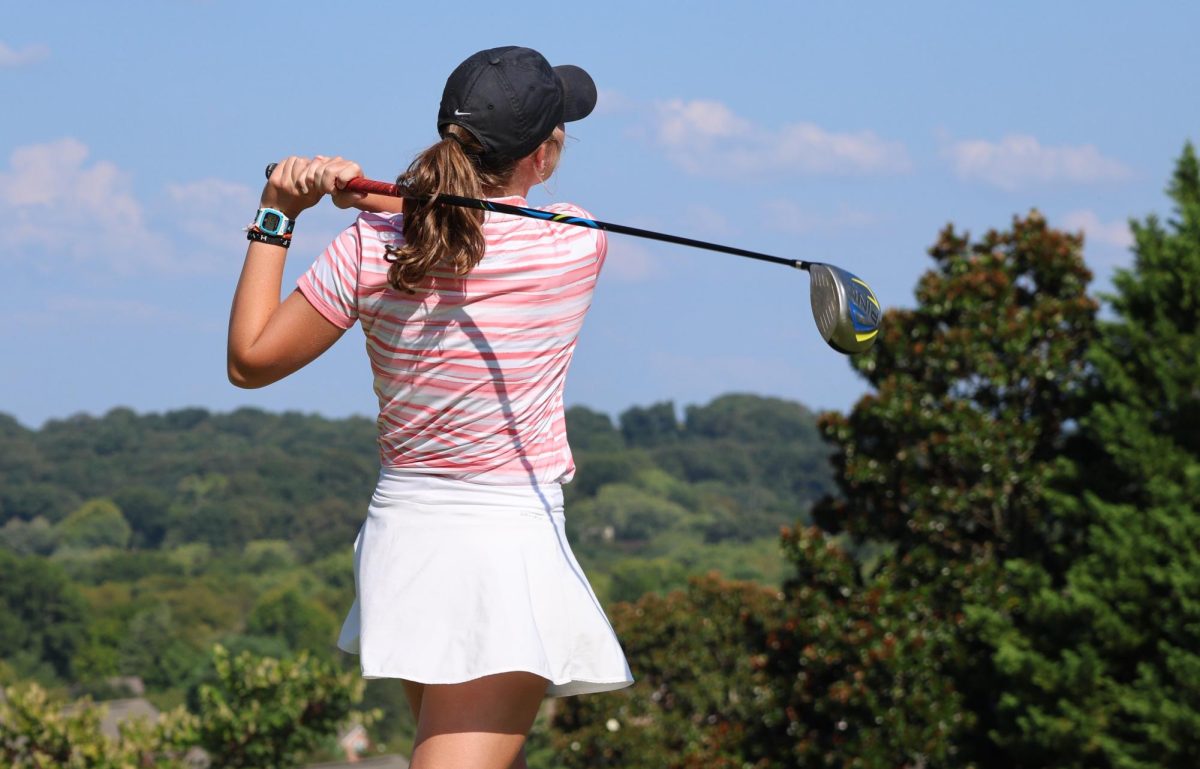 Senior Addi Kammann watches the flight of the ball after a shot at a recent tournament.