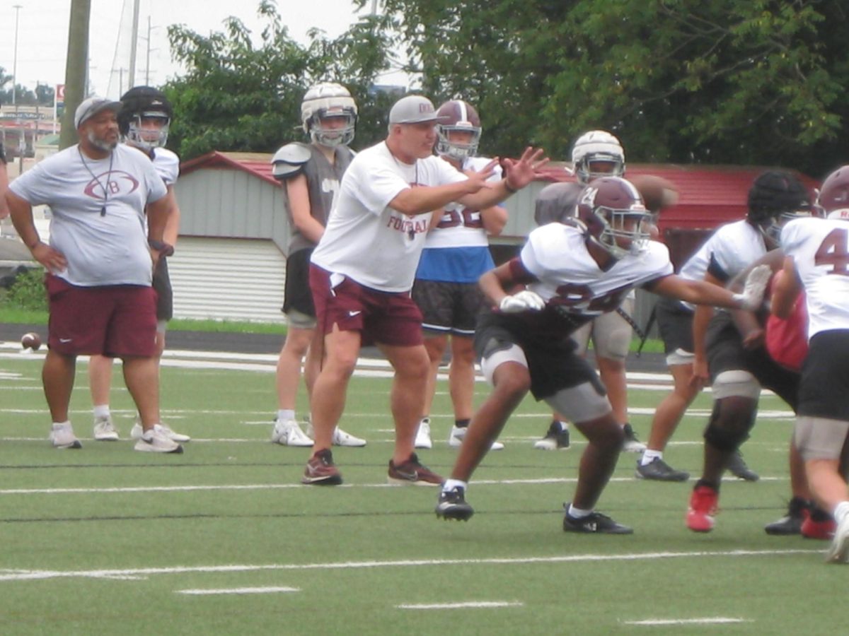 Coach Brad Taylor leads a drill at practice this week. Coach Taylor is excited to be back coaching at his alma mater.