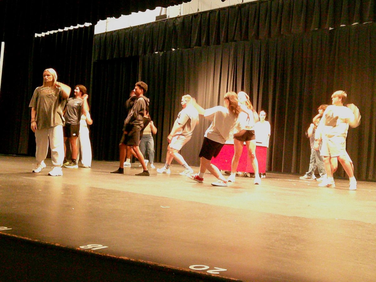 The cast of the fall musical rehearses during fourth block.