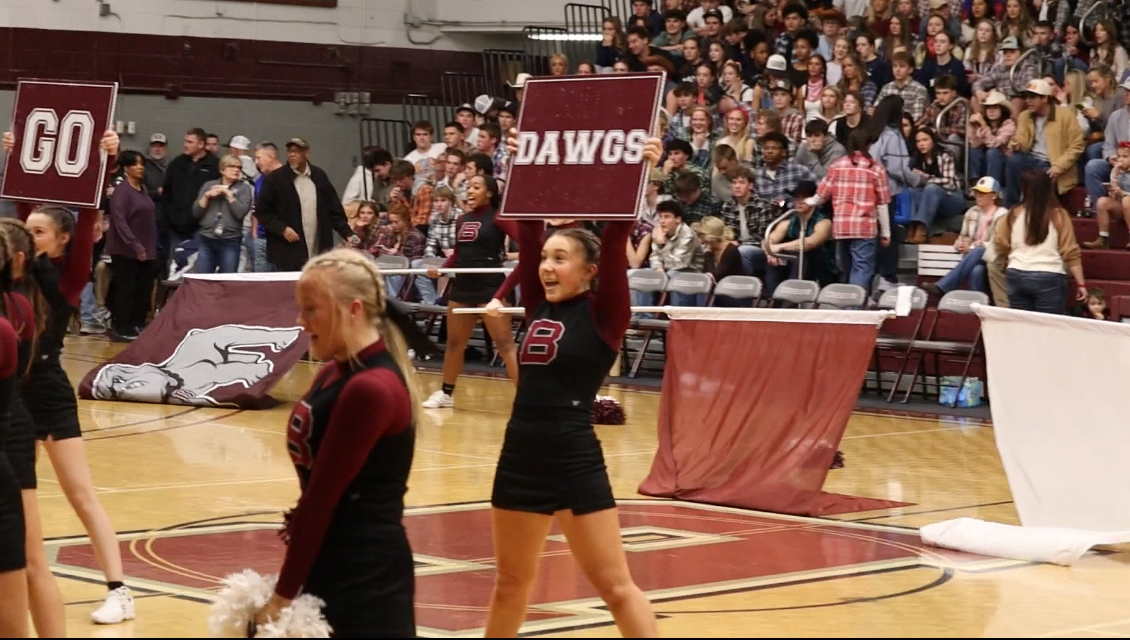 Sophomore Jersey Zizzo performs during a timeout routine at a basketball game.